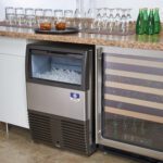 Manitowoc Undercounter Ice maker and wine fridge under bench in a bar